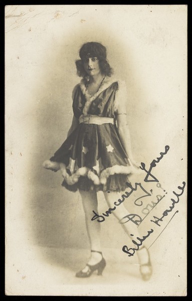 Download the full-sized image of Billie Howell in drag, performing in a costume with a fur trim. Photograph, ca. 1918.