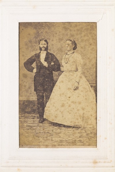 Download the full-sized image of Two men, one in drag, posing as a couple. Photograph, 189-.
