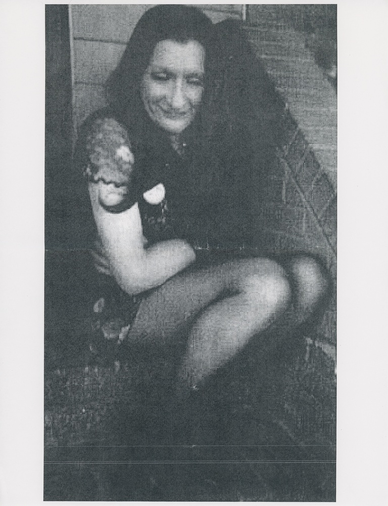Download the full-sized image of A Photograph of Sylvia Rivera Sitting on a Brick Stoop