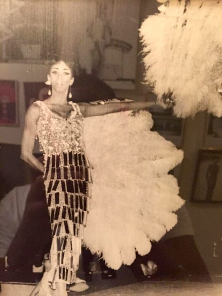Download the full-sized image of A Photograph of Marlow Monique Dickson Posing with Feather Fans