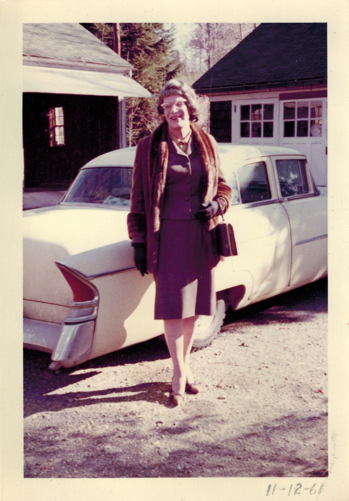 Download the full-sized image of A Photograph of Felicity Chandelle Smiling in Front of a Car
