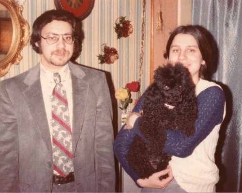 Download the full-sized image of Photograph of Rupert Raj Standing Next to Someone Holding a Dog