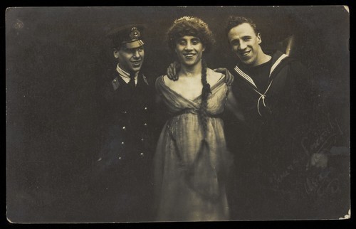 Download the full-sized image of Three sailors with arms round each other. Photographic postcard, 1917.