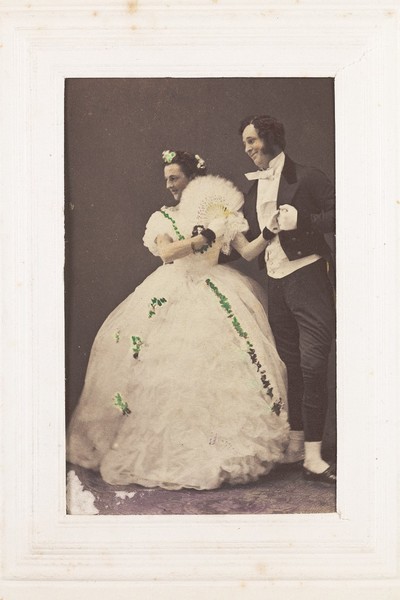 Download the full-sized image of Two men, one in drag, posing as a performing couple. Photograph, 189-.