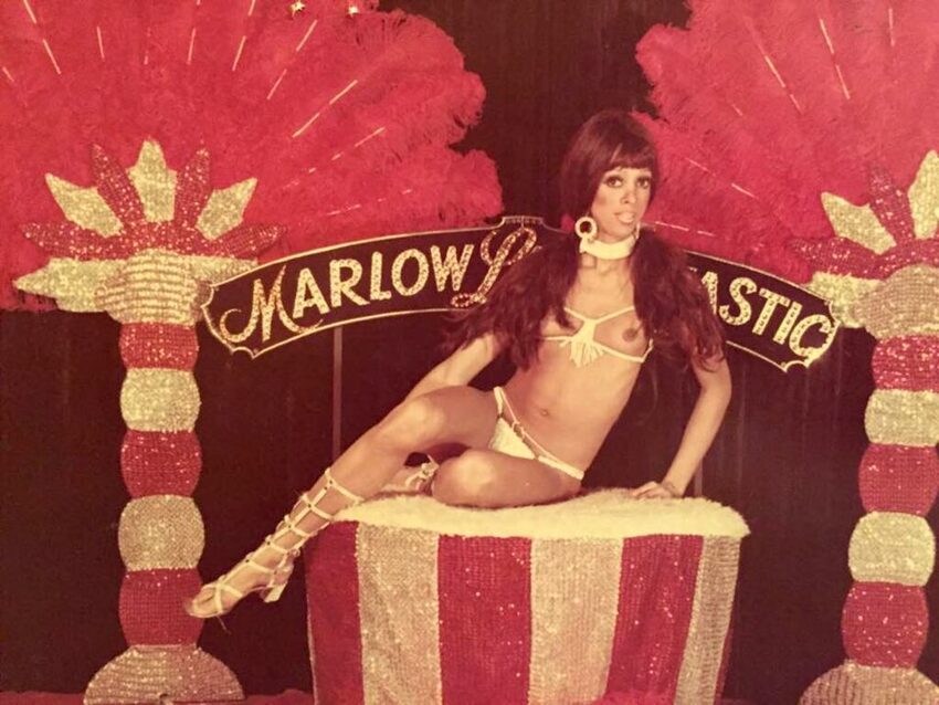 Download the full-sized image of A Photograph of Marlow Monique Dickson Posing in Front of a "Marlow La Fantastic" Sign
